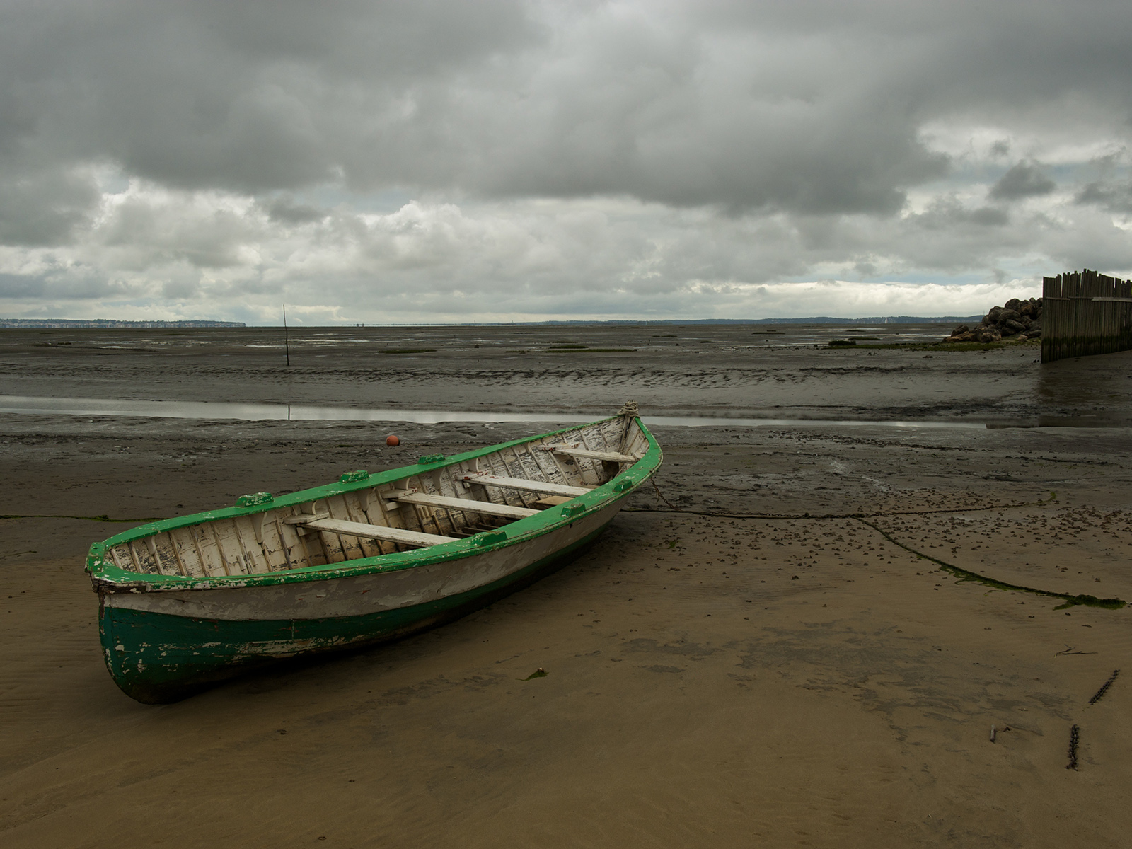 a wooden fishing boat stranded at low tide in the Arcachon Bassin, near Bordeaux, France
