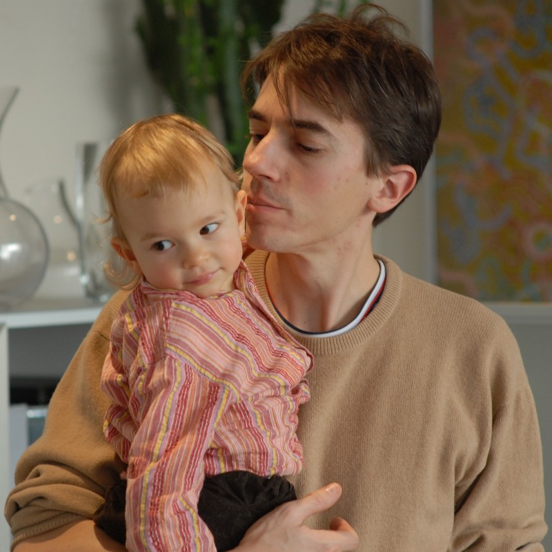 Olivier holding Jeanne in his arms in Paris, France